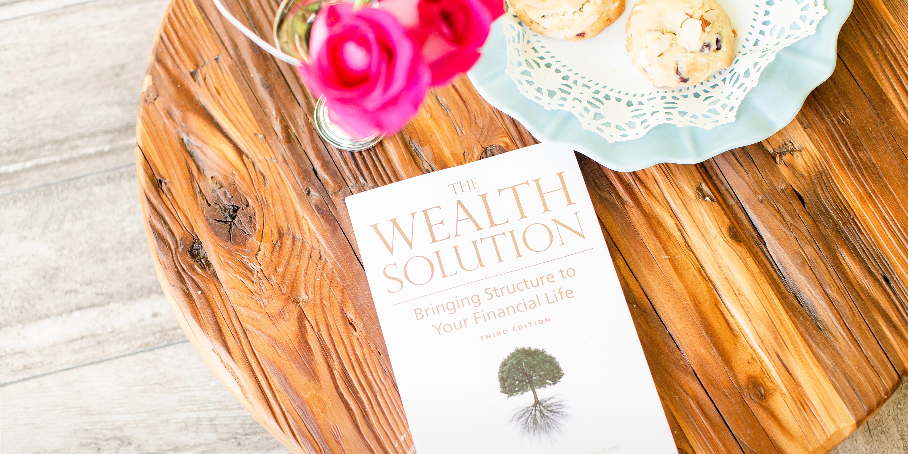 FAQ feature image of wealth solution book on table